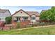 Single-Gathering home with a landscaped yard, a brick patio, and mature trees at 6618 Lynch Ln, Castle Rock, CO 80108
