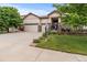 Charming single Gathering home showcasing a three-car garage, beautiful landscaping, and inviting front porch at 6618 Lynch Ln, Castle Rock, CO 80108