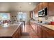 Modern kitchen featuring granite countertops, stainless steel appliances, and wooden cabinets at 6618 Lynch Ln, Castle Rock, CO 80108