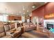 Open floorplan with a cozy living room featuring a fireplace and seamless transition to the kitchen at 6618 Lynch Ln, Castle Rock, CO 80108