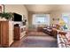 Open concept living area with hardwood floors, comfortable leather sofa, and a large tv at 6618 Lynch Ln, Castle Rock, CO 80108