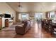 Open concept living room with hardwood floors, large windows, and a comfortable leather sofa at 6618 Lynch Ln, Castle Rock, CO 80108