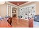 Home office with hardwood floors and built-in shelves, offering a functional workspace with ample storage at 6618 Lynch Ln, Castle Rock, CO 80108