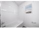 Bright bathroom featuring tiled shower/tub and window at 1175 Highview Dr, Erie, CO 80516