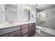 Bright bathroom with double sink vanity, glass shower, and modern fixtures at 1175 Highview Dr, Erie, CO 80516