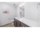 Bathroom featuring sink with wooden cabinets and a tiled wall behind the toilet at 1175 Highview Dr, Erie, CO 80516