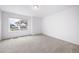 Bedroom with large window offering natural light, and neutral carpeting at 1175 Highview Dr, Erie, CO 80516