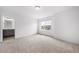 Bedroom with neutral carpet, window, and entrance to ensuite bathroom at 1175 Highview Dr, Erie, CO 80516