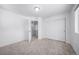 Bedroom featuring neutral carpet, closet with sliding doors, and entrance to walk-in closet at 1175 Highview Dr, Erie, CO 80516