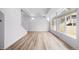 Large, bright living space featuring modern hardwood flooring, recessed lighting, and large windows at 1175 Highview Dr, Erie, CO 80516