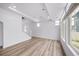 Spacious living area with modern hardwood floors, recessed lighting and large window at 1175 Highview Dr, Erie, CO 80516