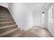 Entryway featuring a carpeted staircase and neutral-colored walls at 1175 Highview Dr, Erie, CO 80516