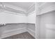 Spacious walk-in closet with multiple levels of shelving and carpeting at 1175 Highview Dr, Erie, CO 80516
