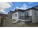 New construction home shows backyard with small porch and under-porch storage in Colorado at 17136 W 92Nd Loop, Arvada, CO 80007