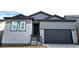 New construction shows a Craftsman style home in gray with stone accents and a two car garage at 17136 W 92Nd Loop, Arvada, CO 80007