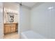 Tiled bathroom with shower and vanity with generous counter space and ample lighting at 14006 E Stanford Cir # K04, Aurora, CO 80015
