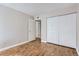 Spacious bedroom featuring a large closet and wood-look floors at 14006 E Stanford Cir # K04, Aurora, CO 80015