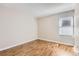 Bright, minimalist bedroom with wood floors and good natural light at 14006 E Stanford Cir # K04, Aurora, CO 80015