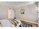 Bright bedroom with a glimpse into the bathroom and walk in closet at 14006 E Stanford Cir # K04, Aurora, CO 80015