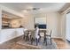 Well-lit dining area with wood floors, modern light fixture, and direct access to kitchen at 14006 E Stanford Cir # K04, Aurora, CO 80015