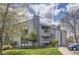 Modern multi-Gathering home with neutral tones, balconies, chimney, and well-maintained front lawn and landscaping at 14006 E Stanford Cir # K04, Aurora, CO 80015