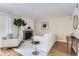 Bright living room features stone fireplace, wood floors, and neutral decor at 14006 E Stanford Cir # K04, Aurora, CO 80015