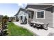Spacious backyard features a patio with an outdoor dining table, BBQ, and manicured lawn at 4635 S Odessa St, Centennial, CO 80015