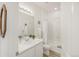 Clean bathroom with a single vanity, light wooden floors and shower-tub combo, radiating a fresh aesthetic at 4635 S Odessa St, Centennial, CO 80015