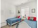 Bright bedroom featuring twin beds with white frames and vibrant blue bedding, complemented by natural light at 4635 S Odessa St, Centennial, CO 80015