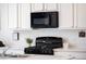 Bright kitchen with stainless steel appliances, white cabinetry, and quartz countertops at 4635 S Odessa St, Centennial, CO 80015