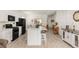 Bright kitchen features a large island, white cabinetry, and modern black appliances at 4635 S Odessa St, Centennial, CO 80015