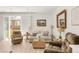 Cozy living room with neutral tones, comfortable seating, and sliding glass doors at 4635 S Odessa St, Centennial, CO 80015