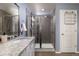 Modern bathroom featuring a glass-enclosed shower, granite countertop vanity and neutral color palette at 5421 S Granby Way, Aurora, CO 80015