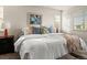 Bright bedroom with large bed, neutral decor, bedside lamps, and sunny windows at 5421 S Granby Way, Aurora, CO 80015