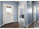 Inviting entryway with hardwood floors, a glass front door, and a view into the home office at 5421 S Granby Way, Aurora, CO 80015