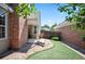 Backyard view featuring brick patio, artificial grass, and fenced yard, perfect for outdoor enjoyment at 5351 S Cody St, Littleton, CO 80123