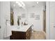 Bathroom featuring double sinks, walk-in shower, and decorative mirror at 5351 S Cody St, Littleton, CO 80123