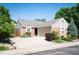 Well-maintained home with manicured landscaping, large driveway, and attached two-car garage at 5351 S Cody St, Littleton, CO 80123