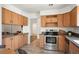 Bright kitchen showcasing wood cabinets, stainless steel appliances, and ample counter space at 5351 S Cody St, Littleton, CO 80123