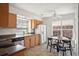 Well-lit kitchen features stainless steel appliances, wooden cabinets, and an adjacent dining area at 5351 S Cody St, Littleton, CO 80123