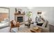 Bright living room with fireplace, stylish furnishings, and ample natural light from the sliding doors and windows at 5351 S Cody St, Littleton, CO 80123