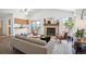Bright living room boasts a fireplace, vaulted ceilings, and sliding glass doors to backyard at 5351 S Cody St, Littleton, CO 80123