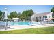 Community pool featuring diving boards, umbrellas, lounge chairs, and a two story building in the background at 5351 S Cody St, Littleton, CO 80123