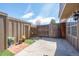 Enclosed backyard with a mix of concrete and artificial turf, and a wooden gate at 7101 W Yale Ave # 3403, Denver, CO 80227