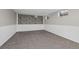 Spacious carpeted basement with a stone accent wall and white wainscotting at 7101 W Yale Ave # 3403, Denver, CO 80227