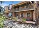 Charming brick townhome with a cozy balcony and beautifully landscaped front yard at 7101 W Yale Ave # 3403, Denver, CO 80227