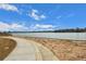 Scenic lake view with sandy beach area and a paved path for walking and enjoying the natural beauty at 7101 W Yale Ave # 3403, Denver, CO 80227