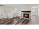 Bright living room features a cozy fireplace, wood floors, and an open layout at 7101 W Yale Ave # 3403, Denver, CO 80227