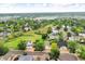 Wide aerial view captures the residential community, surrounding parklands, and distant cityscape at 5960 S Estes St, Littleton, CO 80123