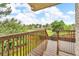 Enjoy the outdoors from this back deck featuring a wooden railing with a large green area and trees at 5960 S Estes St, Littleton, CO 80123